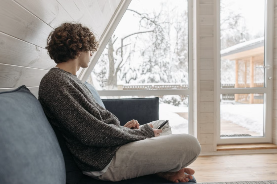 A man warm in his home who has recently replaced his furnace air filter. 