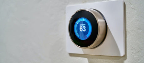 Modern thermostat set to 63 degrees